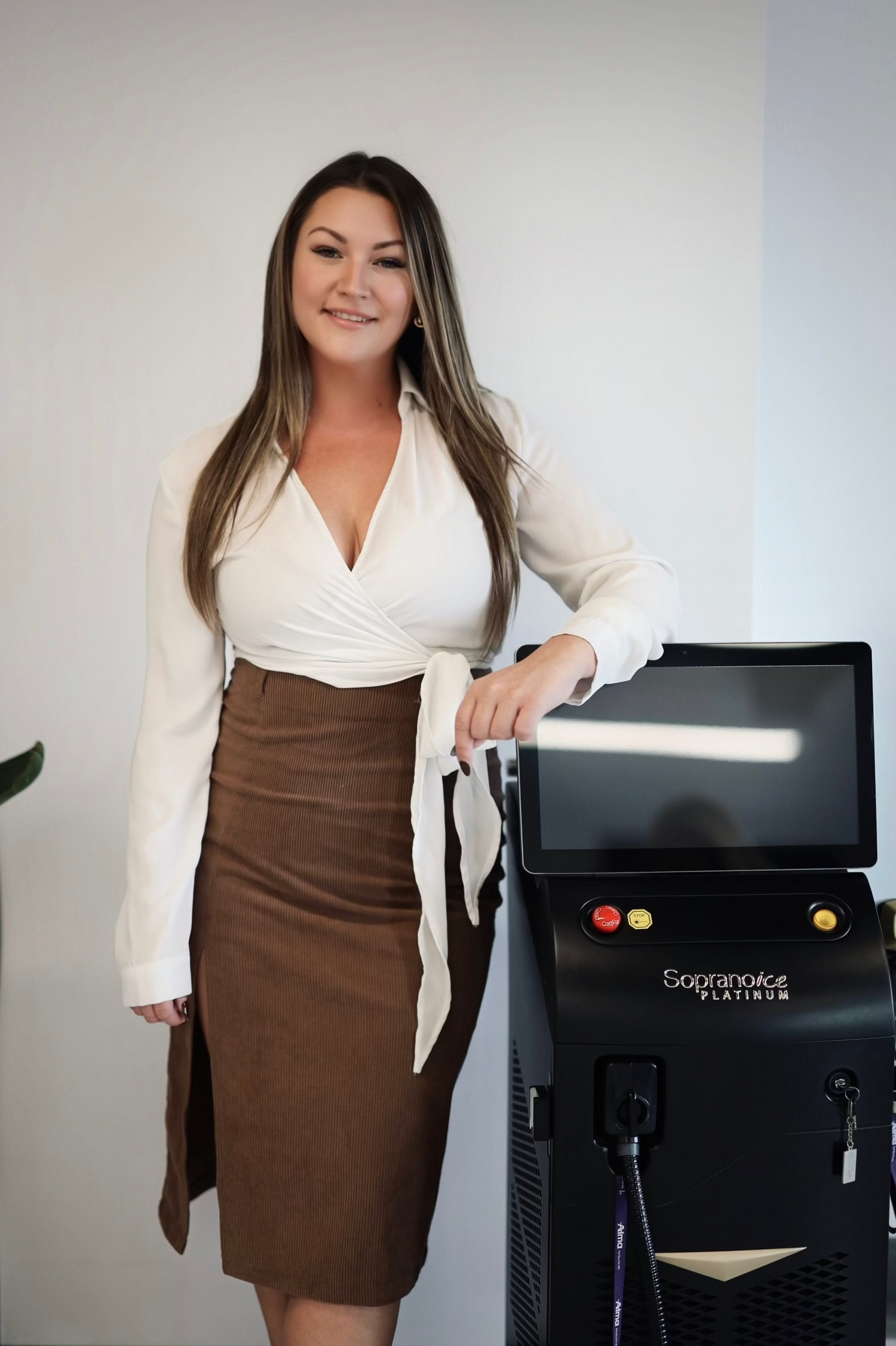 Woman standing next to a laser hair removal machine